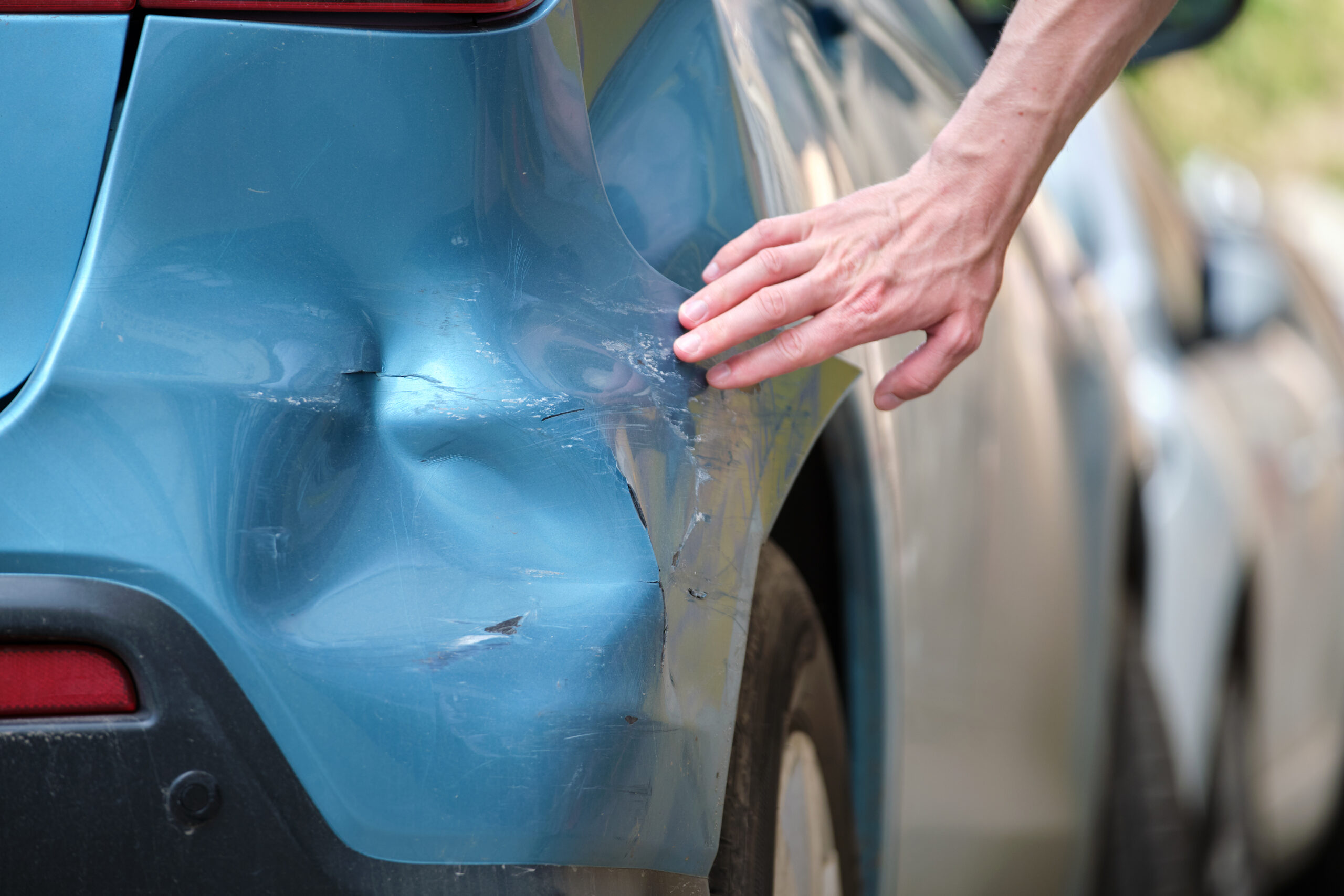 Man checking car damage after an accident