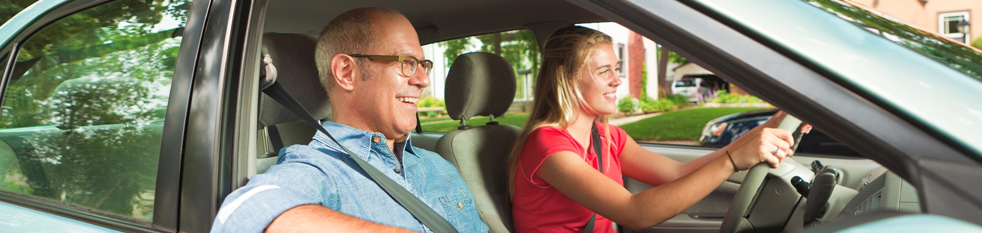 Daughter and father driving in a car