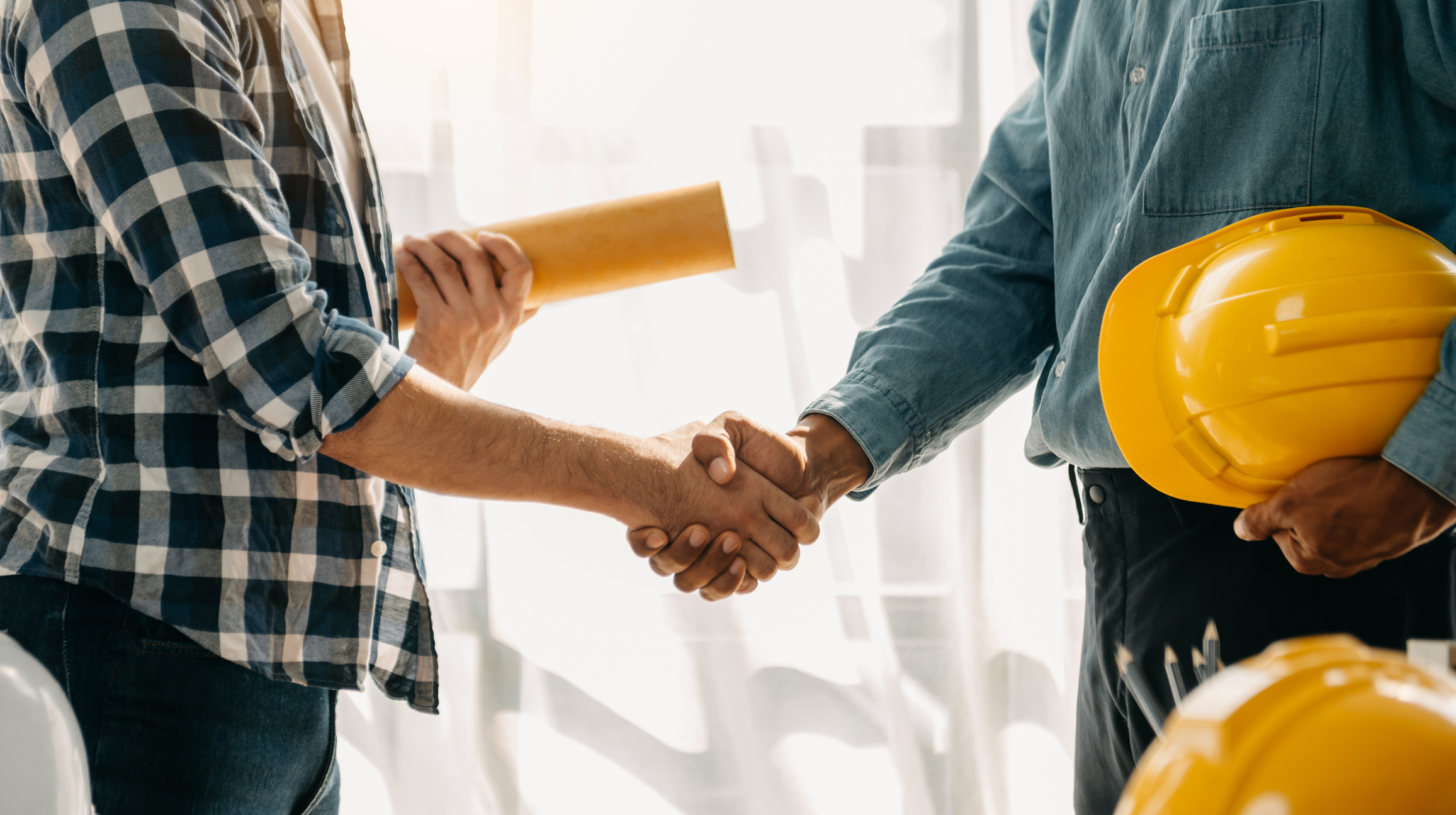 Construction workers shaking hands