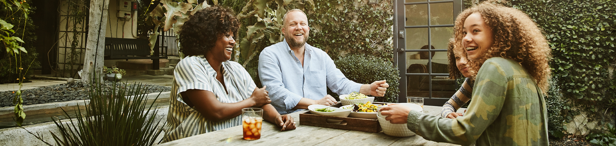 Family enjoying a meal on patio