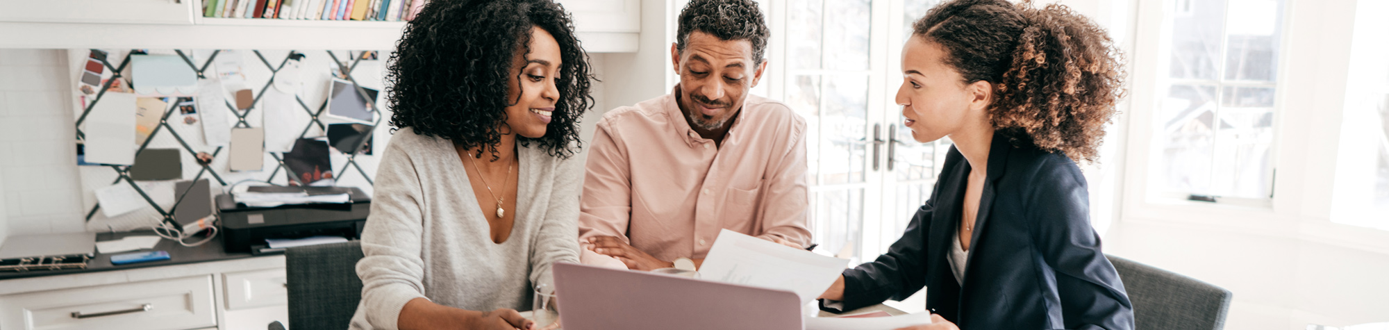 Agent reviewing insurance documents with couple