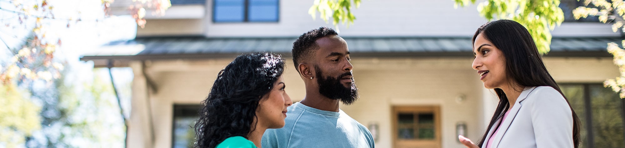 Couple talking to agent outside