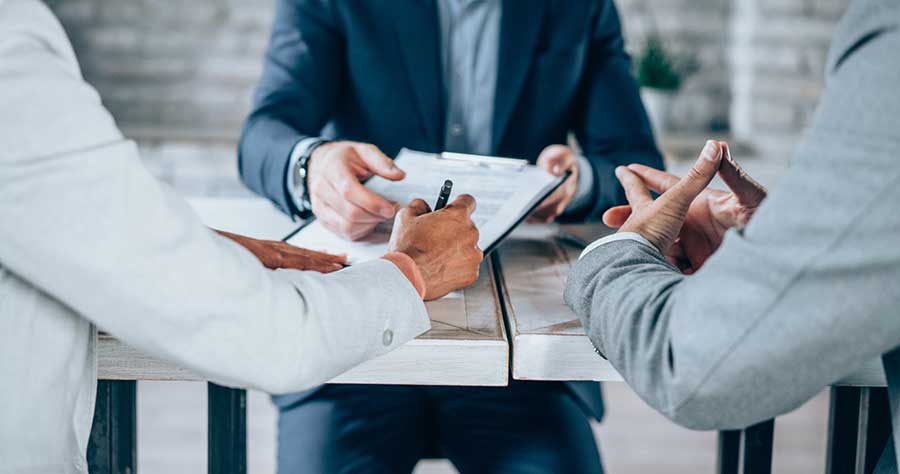 Professionals signing a document